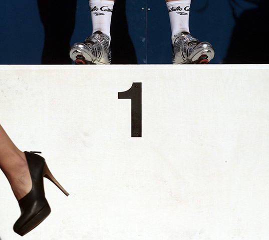 Pix of the week: A hostess leaves while race winner Mark Cavendish stands on the podium