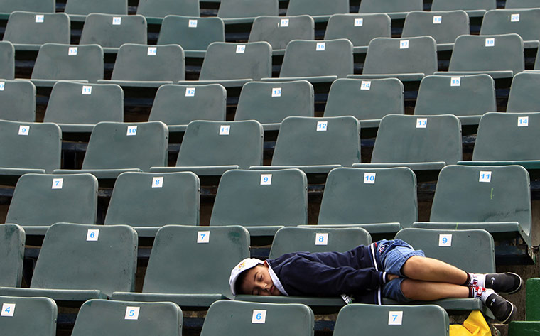 Pix of the week: A boy sleeps before the final of the Romanian Open tennis tournament