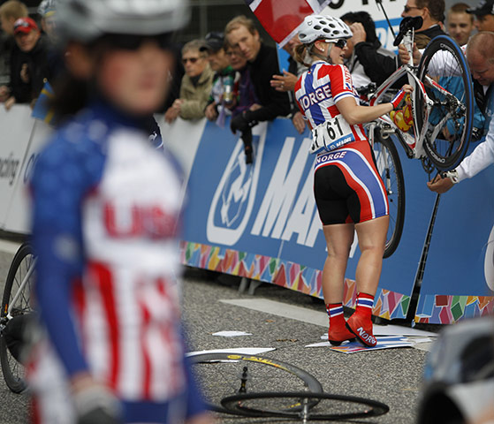 Pix of the week: Norway's Pia Charlotte gets assistance from a spectator who fixes her bike