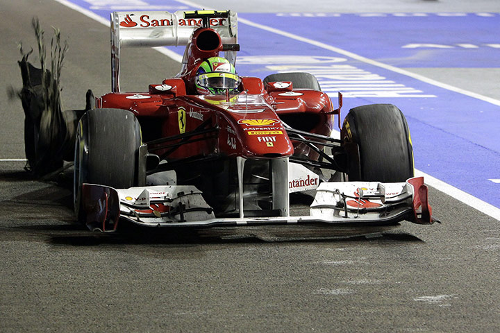 Singapore Grand Prix: Felipe Massa comes into the pits after a collision with Lewis Hamilton
