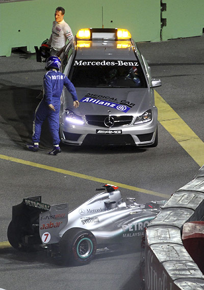 Singapore Grand Prix: Michael Schumacher gets into a medical car following a crash