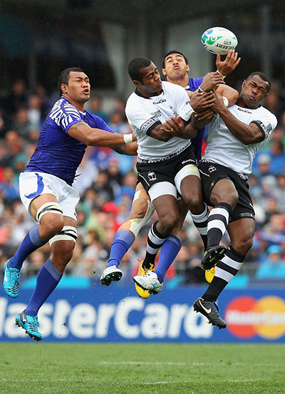 Fiji v Samoa: Fiji and Samoa players battle for a high ball