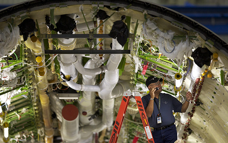 boeing 787 dreamliner: A Boeing employee works inside the fuselage 