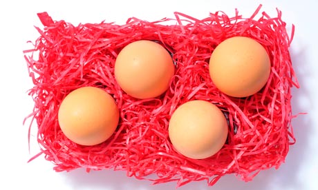 Brown eggs placed on red excelsior