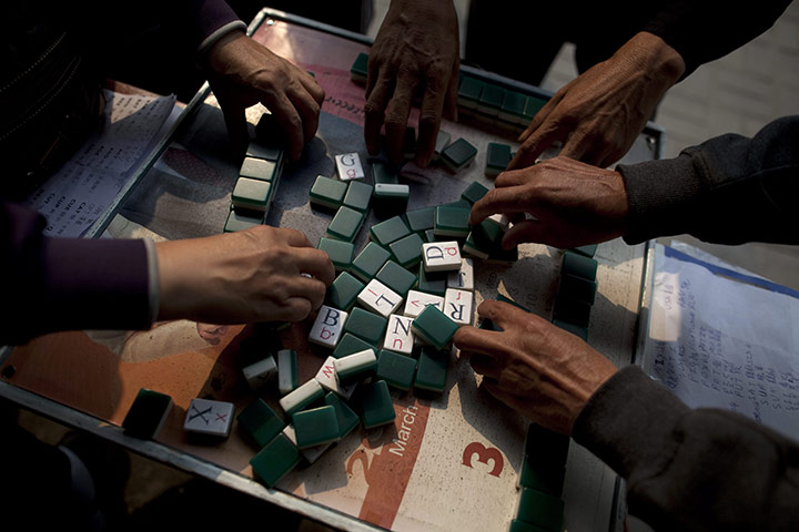 24 hours: Beijing, China: Enthusiasts shuffle English Mahjong tiles