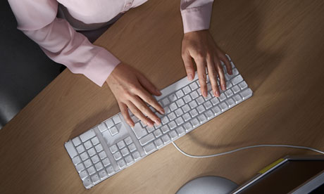 Woman typing on a computer keyboard