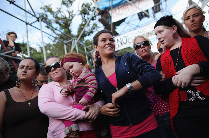 24 hours in pictures: Basildon, UK: Travellers gather in front of the main gate at Dale Farm
