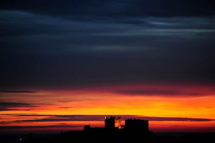 24 hours in pictures: Bamburgh, UK: The sun rises over Bamburgh Castle