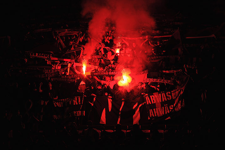 Champions League Tuesday: The Basel fans at Old Trafford light flares ahead of the match