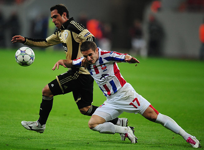 Champions League Tuesday: Benfica's Bruno Cesar vies for the ball with Laurentiu Bus of Otelul Galati