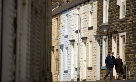 Pensioners walking pased a terraced house in Burnley, Lancashire.