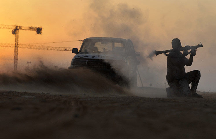 24 hours in pictures: A rebel fighter fires a rocket-propelled grenade in Libya