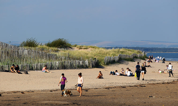 Hot weather in the UK: People enjoy the unseasonable weather conditions, St Andrew Beach, Scotland