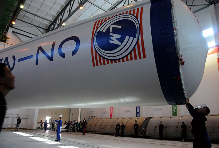 China space launch: Workers prepare the Long March II-F carrier rocket