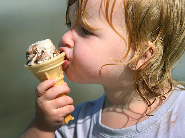 Hot Weather in the UK: A two year old enjoys an ice-cream in Folkestone