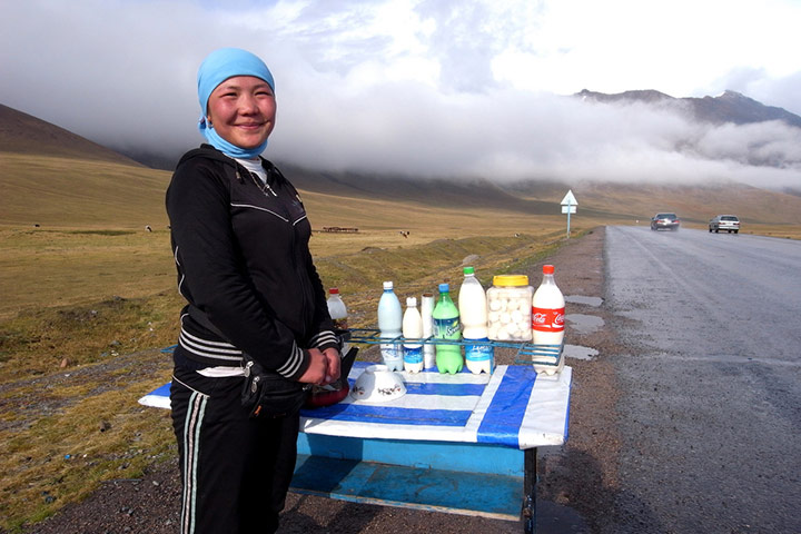 MarcinMonko assignment: 2: Kyrgyz girl selling kumys at Ala-Bel pass (3175 m) in Kyrgyzstan