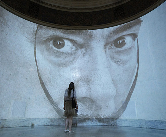 24 Hours: A visitor looks at a projection of Salvador Dali at Moscow's Pushkin Museum