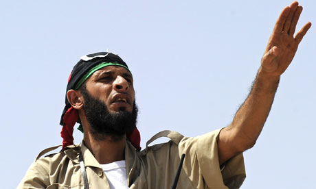 A National Transitional Council fighter mans a checkpoint on the road to Bani Walid