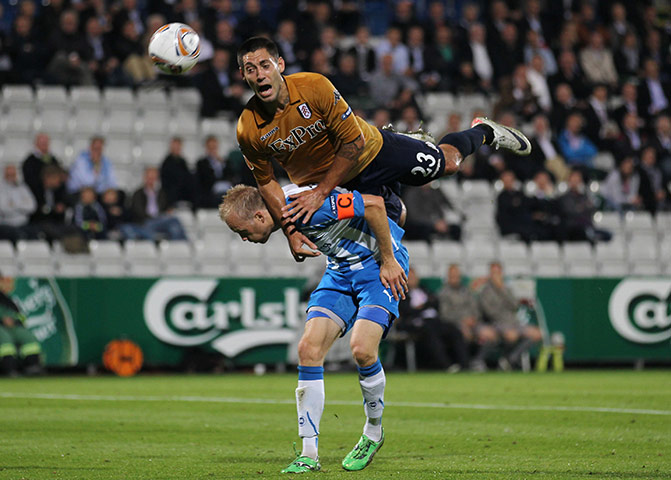 Europa League: Odense's Anders Moller Christensen tries to avoid a flying Clint Dempsey