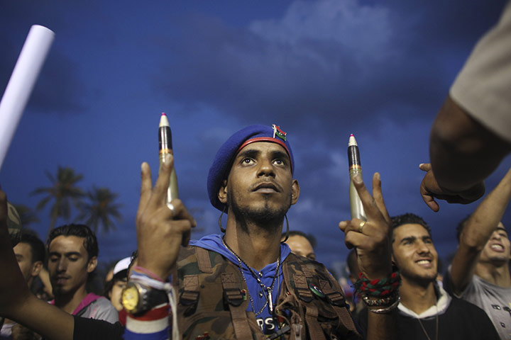 24 hours in pictures: Tripoli, Libya: A revolutionary fighter holds ammunition