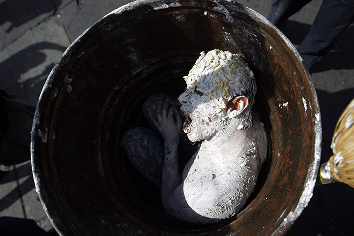 24 hours in pictures: Mexico City, Mexico: An activist, covered in flour and corn grains