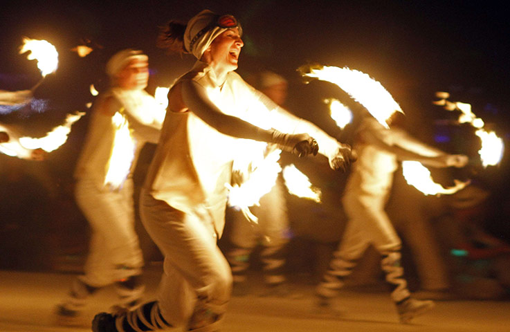 24 hours: Nevada, USA: Fire dancers with the LA Fire Brigade perform at Burning Man