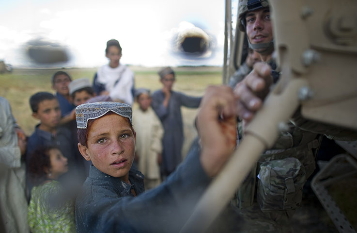 24 hours: Hasti, Afghanistan: A soldier speaks with young boys
