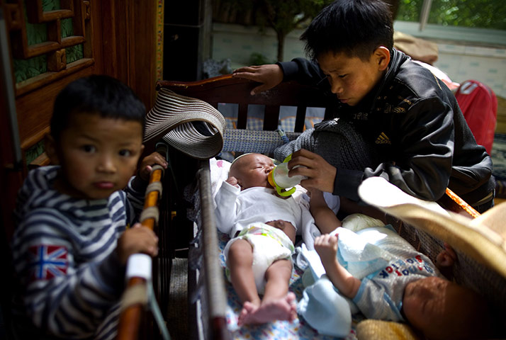 24 hours: Lhasa city, Tibet: A 12-year-old Tibetan orphan feeds two baby orphans 