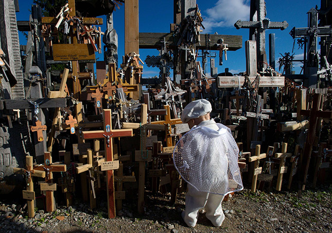 24 hours: Siauliai, Lithuania: A boy plays on the Hill of Crosses pilgrimage site