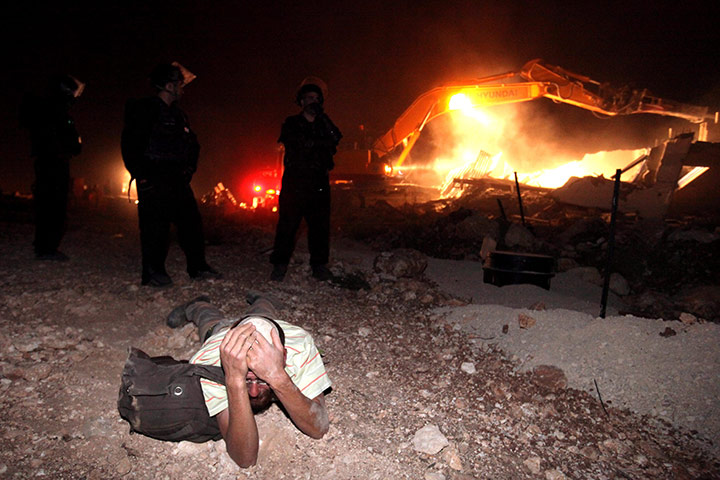 24 hours: Migron, West Bank: A Jewish settler cries after his house was destroyed