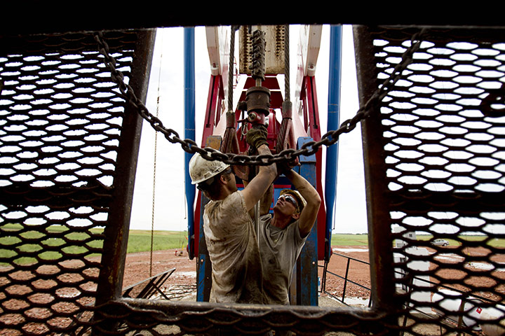 Oil in North Dakota: Austin Mitchell, left, and Ryan Lehto, work on an oil derrick 