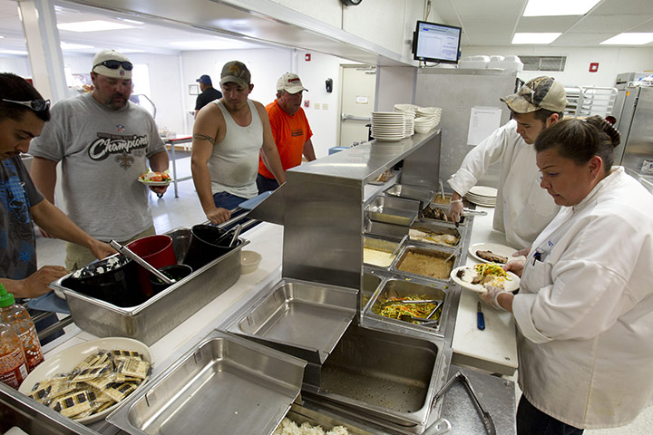 Oil in North Dakota: Workers line up for dinner at a temporary housing unit 