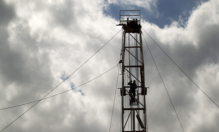 Oil in North Dakota: Ben Shaw works at the top of an oil derrick 