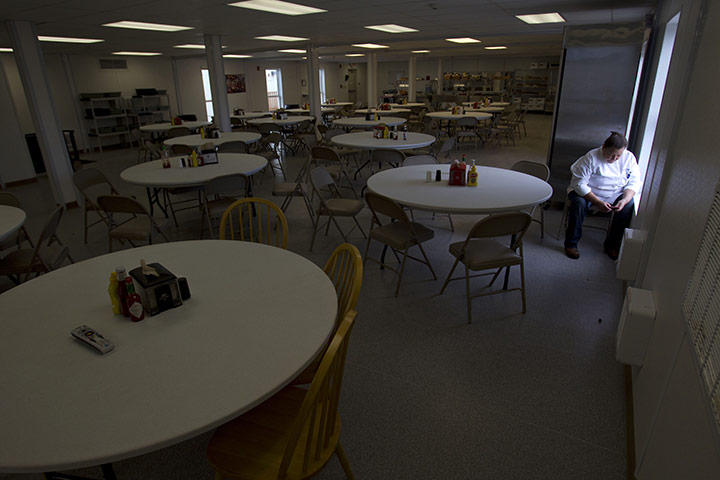 Oil in North Dakota: Cook Sharron Tallent checks her cellphone for a text as she takes a break 