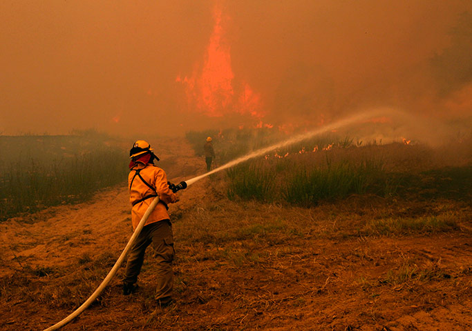Texas Wildfires: Firefighters from around the state battle a wildfire near Smithville, Texas