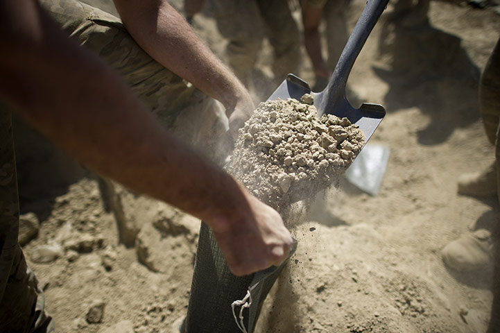 24 hours in pictures: US army soldiers fill sandbags in Afghanistan
