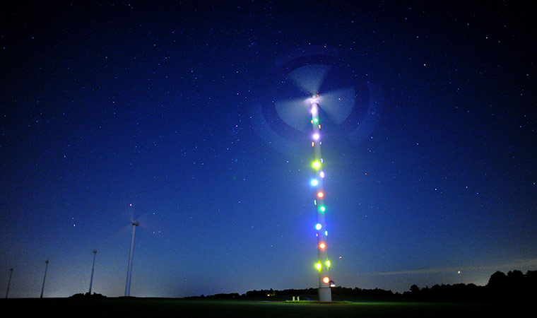 24 hours in pictures: A wind turbine is illuminated by an installation by Patrick Raynaud 