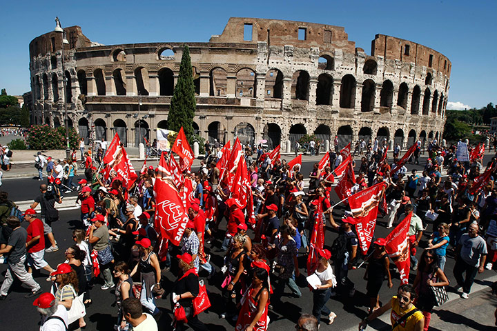 Italy strike: Demonstrators march past the Colosseum during a general strike in Rome