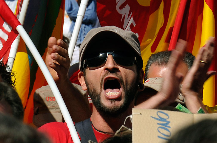 Italy strike: A man shouts during a general strike in Turin
