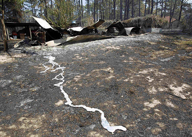 Wildfires damage: Melted aluminium leaks from inside a burnt shed near Bastrop