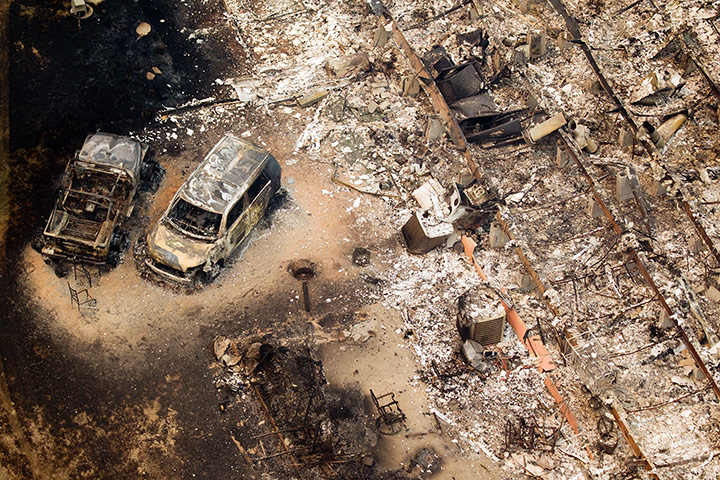 Wildfires damage: A burnt out house and cars near Magnolia