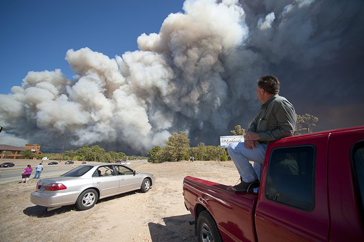 Wildfires damage: A Bastrop resident watches a wildfire burn the forest east of the city