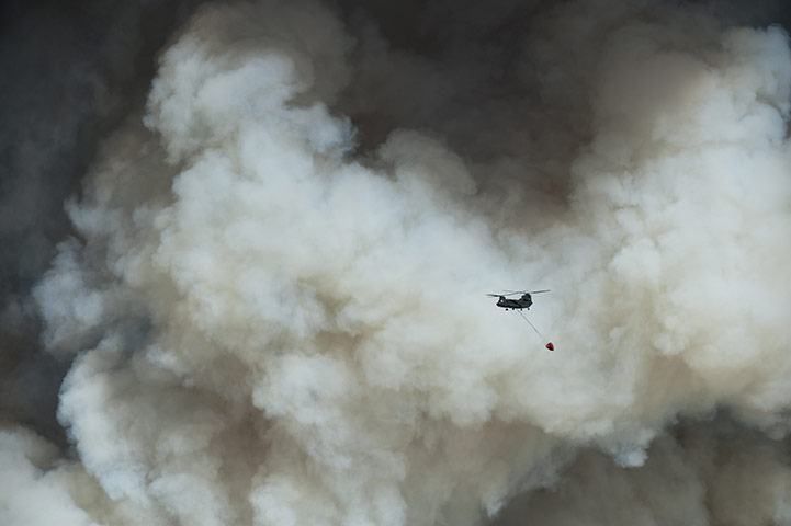 Wildfires damage: A Chinook helicopter attempts a water drop in the forest east of Bastrop