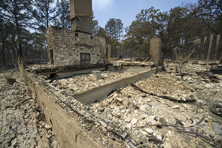 Wildfires damage: Homes, cars, boats and a church lie in ruins along Texas Highway 21 