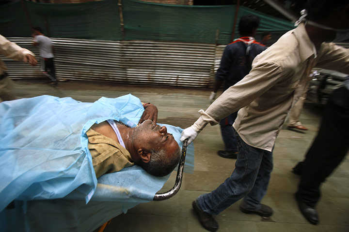 24 hours in pictures: A man injured in a bomb blast arrives at hospital in Delhi