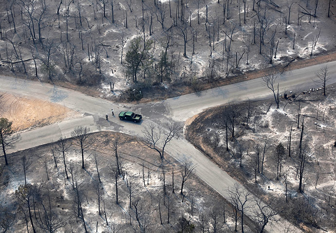 24 hours in pictures: A car drives through an area damaged by wildfires in Texas