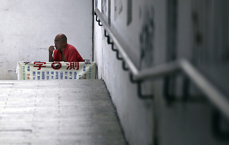 24 hours in pictures: A street fortune teller in Shanghai, China