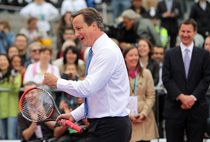 Cameron plays tennis : The Prime minister pumps his fist after winning a point