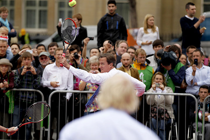 Cameron plays tennis : Cameron plays a backhand as Johnson looks on