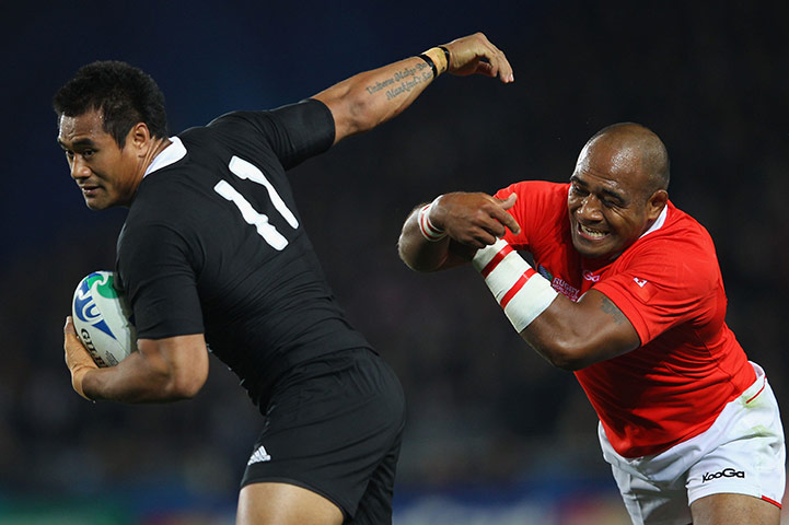 RWC game 1: New Zealand's Isaia Toeava evades a tackle from Tonga's Aleki Lutui 